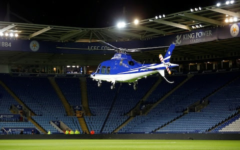 General view as a helicopter lands in the stadium at the end of the match