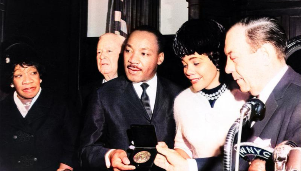 Dr. Martin Luther King accepting nobel peace prize with his wife and the president