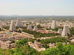 Set of temple towers with urban centre and hill range in the background
