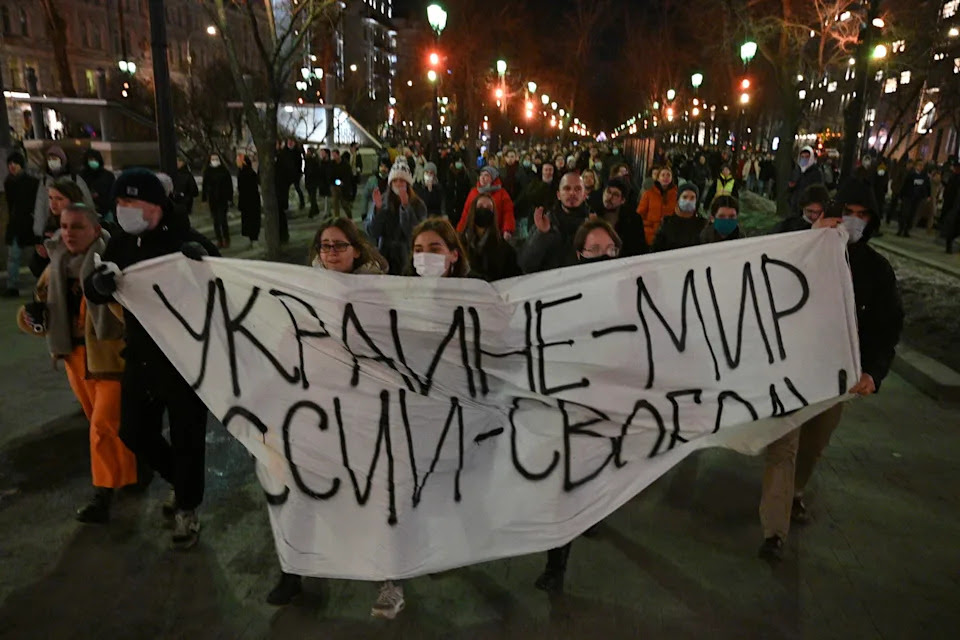 Demonstrators march with a banner that reads: Ukraine - Peace, Russia - Freedom, in Moscow, Russia, Thursday, Feb. 24, 2022, after Russia's attack on Ukraine. Hundreds of people gathered in the center of Moscow on Thursday, protesting against Russia's attack on Ukraine. Many of the demonstrators were detained. Similar protests took place in other Russian cities, and activists were also arrested. (AP Photo/Dmitry Serebryakov)