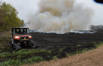 prescribed burn on field with fire equipment