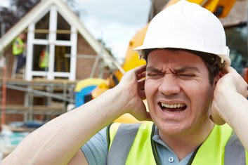 Construction worker holding ears