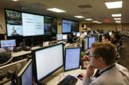 Man at computer in large office