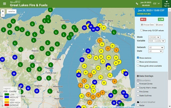a blue, green, orange, red and yellow map of Michigan showing circles with letter indications of fire risk, ranging from LOW to EXTREME