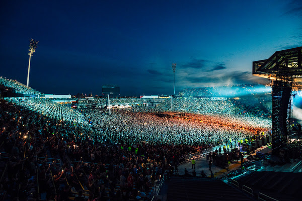 A large crowd of people at a concertDescription automatically generated with medium confidence