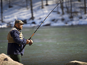 man steelhead fishing in river