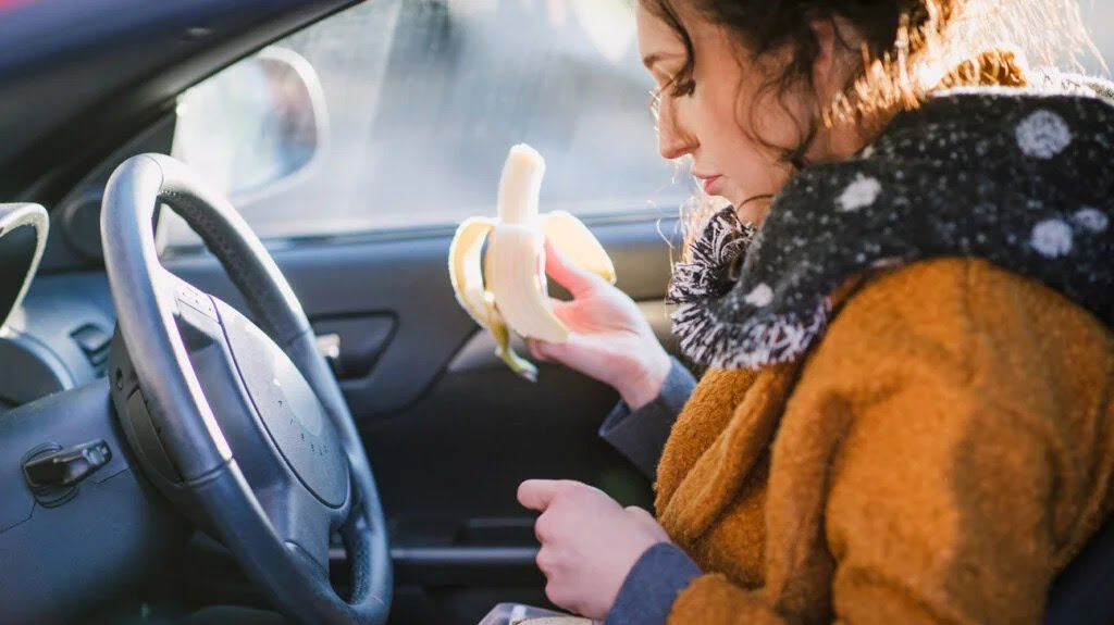 A woman is eating a banana to attempt to stop diarrhea fast