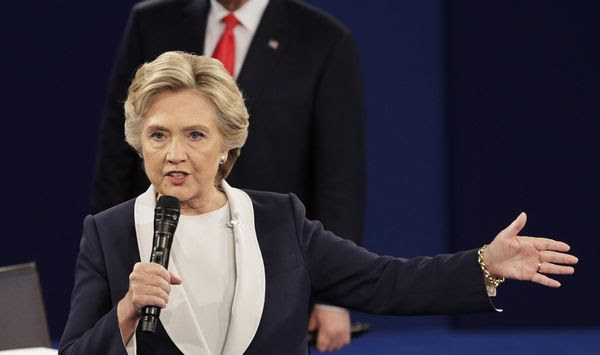 Republican presidential nominee Donald Trump listens to Democratic presidential nominee Hillary Clinton during the second presidential debate at Washington University in St. Louis on Oct. 9, 2016. (Associated Press) **FILE**