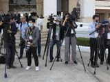 Media wear face masks to protect themselves from a new virus wait China&#39;s Foreign Minister Wang Yi&#39;s arrival at Wattay Airport for the Special ASEAN-China Foreign Ministers&#39; Meeting on the coronavirus disease 2019 (COVID-19) in Vientiane, Laos, Wednesday, Feb. 19, 2020. (AP Photo/Sakchai Lalit)