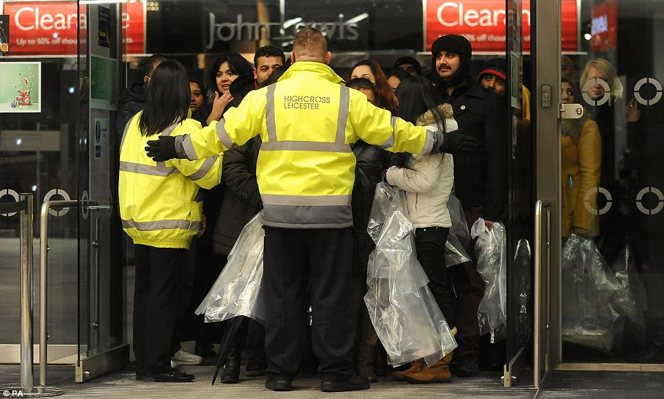 Holding  back the hordes: Security guards at the Highcross centre in Leicester had to stop the crowds from flooding shops