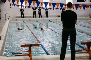 People swim laps in a pool