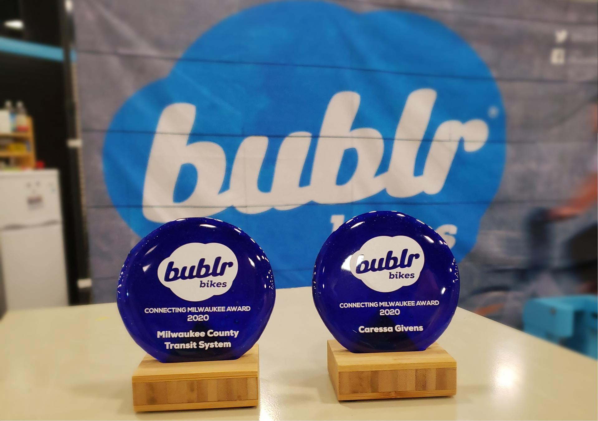 Image of two Connecting Milwaukee awards in front of a bublr branded backdrop