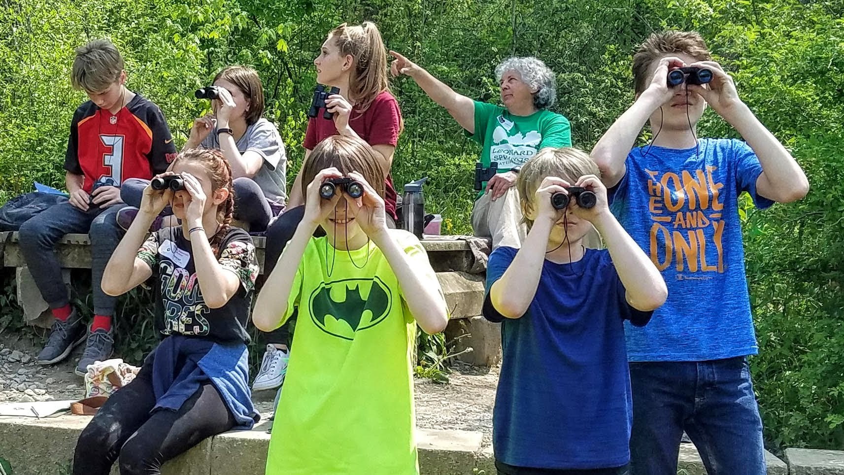 A group of children using binoculars to look out over the wetland at Leonard Springs Nature Park