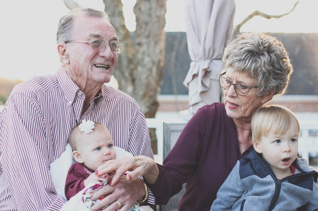 Grandparents holding grandkids