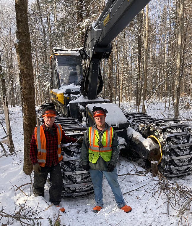 Forestry Instructor Robert Greenier with student Garret Estabrook in front of a Ponsse Fox processor.