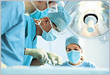 Three doctors performing surgery.