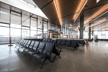 Interior of new terminal building with several seats and large windows