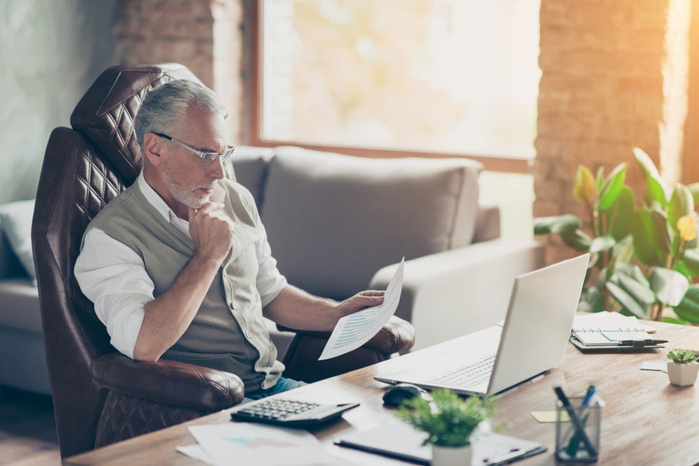 Older gentleman looking over paperwork Older gentleman looking over paperwork