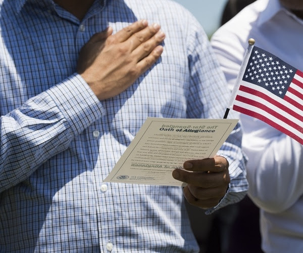 A man with his hand on his heart, reading the Pledge of Allegiance