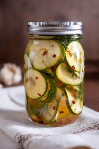 Pickled Zucchini Pickled Zucchini in a Mason Jar with Dill, Crushed Red Pepper and Garlic pickle jar stock pictures, royalty-free photos & images