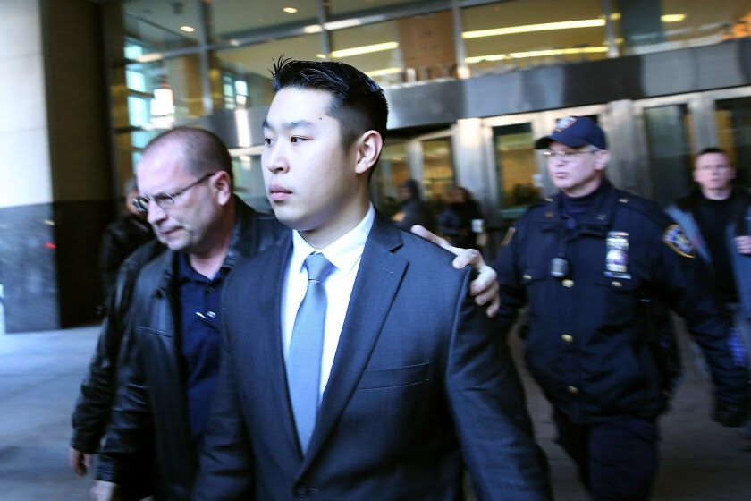 New York City police Officer Peter Liang is escorted out of court after he was charged with manslaughter.