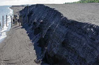A group of experts tours the deposits of stamp sands along the Lake Superior shoreline in August.