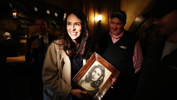 New Zealand Prime Minister Jacinda Ardern holds a drawing given to her by Hobbiton artist Will Bechnan during a tour of Hobbiton. Photo / Getty