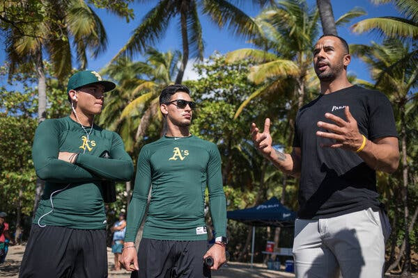 Chris Dickerson, right, formed Players for the Planet, a nonprofit that has cleaned beaches and encouraged players to care for the environment.