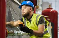 male gas engineer checking pipes