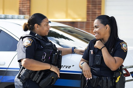 Two female police officers talking to one another