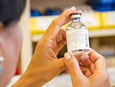 Pharmacist looking at vial