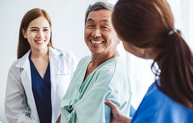 A medical research participant having a discussion with two doctors.