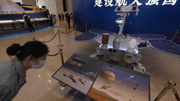  A visitor to an exhibition on China's space programme looks at a life size model of the Chinese Mars rover Zhurong, named after the Chinese god of fire, at the National Museum in Beijing. China has landed a spacecraft on Mars for the first time in the latest advance for its space program. The official Xinhua News Agency said Saturday, May 15, that the lander had touched down, citing the China National Space Administration. 