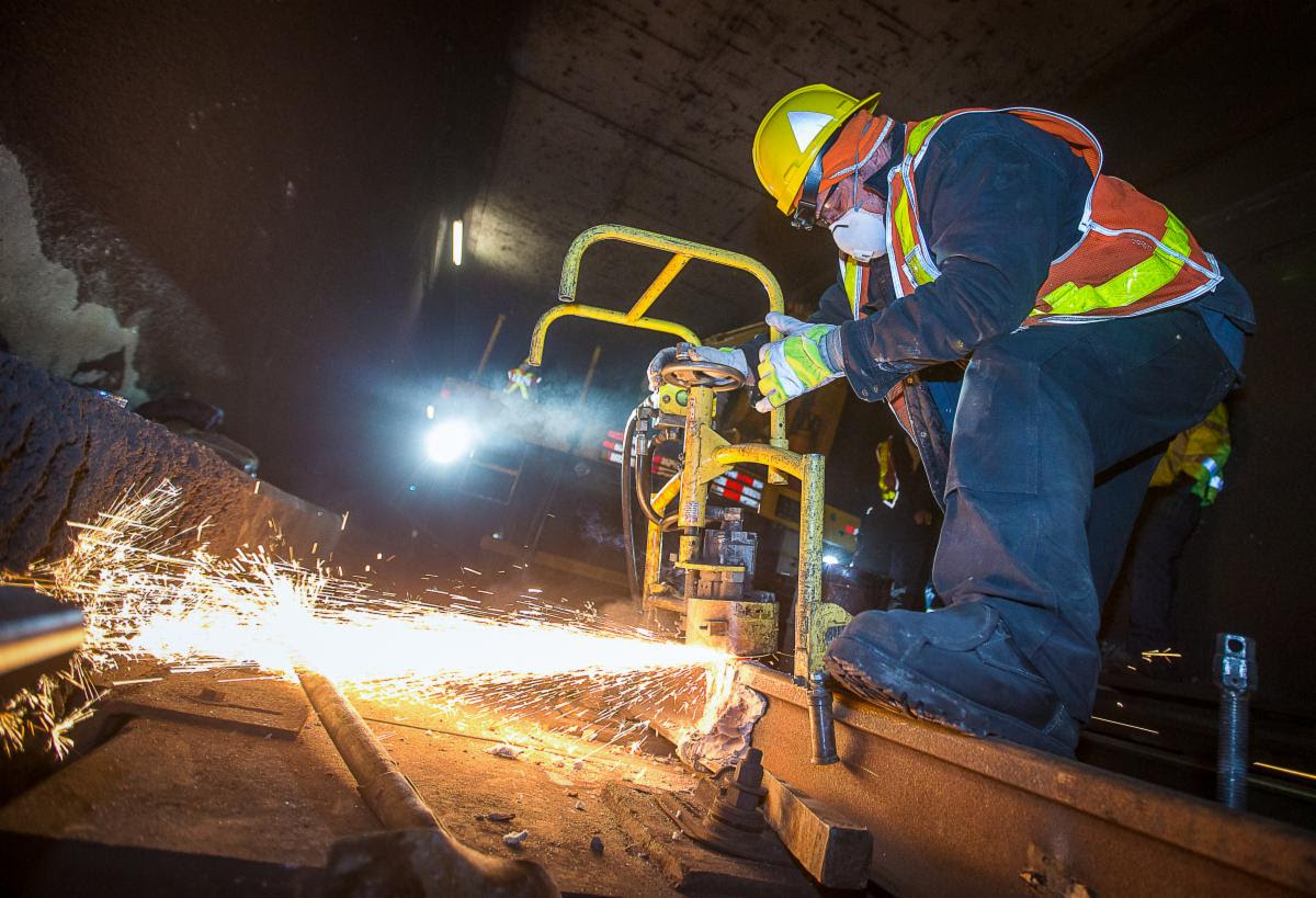 Sparks shoot out as a TTC employee works on a subway track replacement