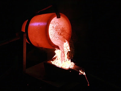 Smelted gold is poured into
                  moulds.