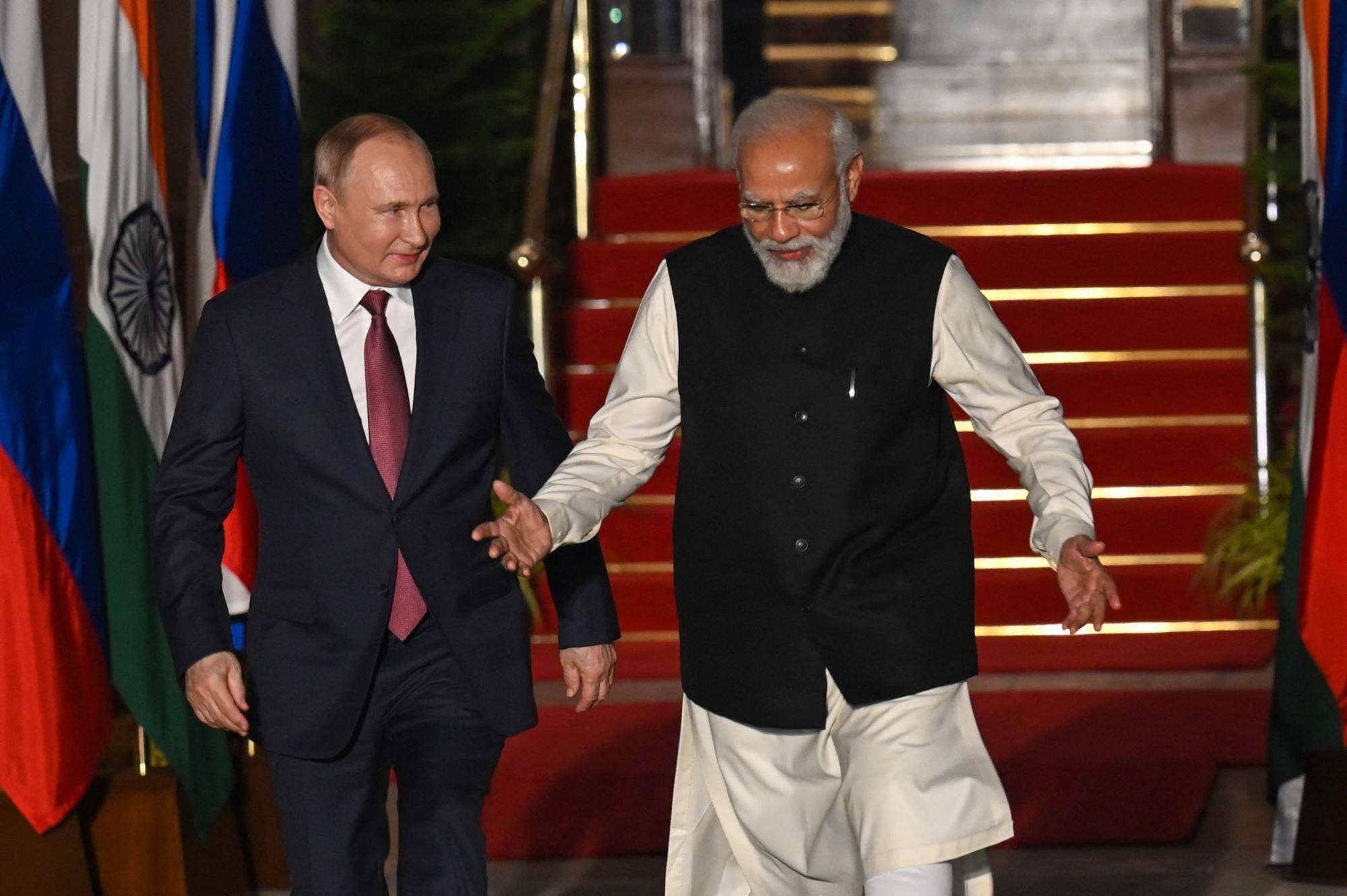 Modi greets Putin before their meeting at Hyderabad House in New Delhi on Monday. Photo: AFP
