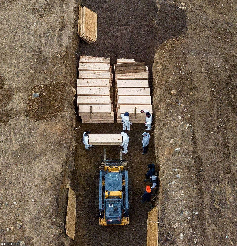 About a dozen workers were seen digging and burying the caskets - some of which had names carved into them - on Thursday as at least one refrigerated truck was brought onto the island