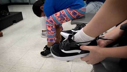 Child trying on new sneakers