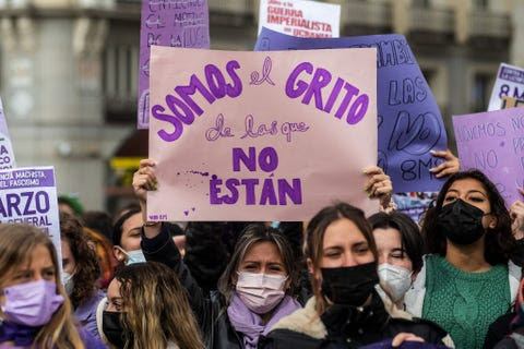 A woman is seen with a placard reading 'We are the cry of... a woman is seen with a placard reading 'we are the cry of
