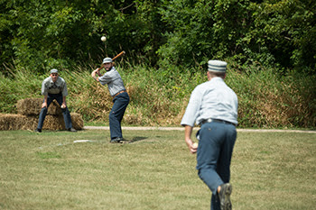 Men playing baseball in vintage uniforms