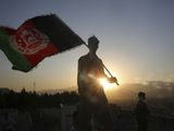 In this Aug. 19, 2019, file photo, a man waves an Afghan flag during Independence Day celebrations in Kabul, Afghanistan. An Afghan official Sunday, Feb. 9, 2020, said multiple U.S. military deaths have been reported in Afghanistan&#39;s Nangarhar province after an insider attack by a man wearing an Afghan army uniform. (AP Photo/Rafiq Maqbool, File) **FILE** 